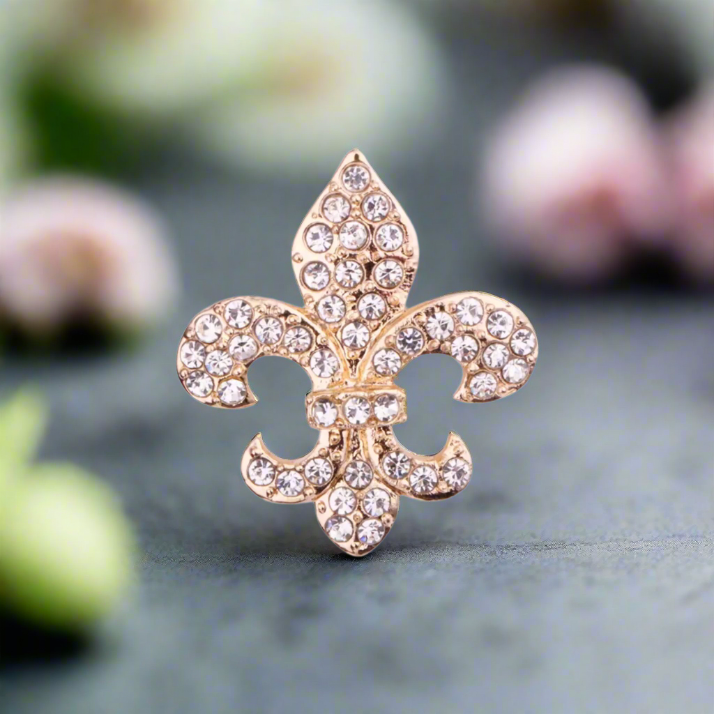 Front view of a silver fleur-de-lis lapel pin on a white dress shirt