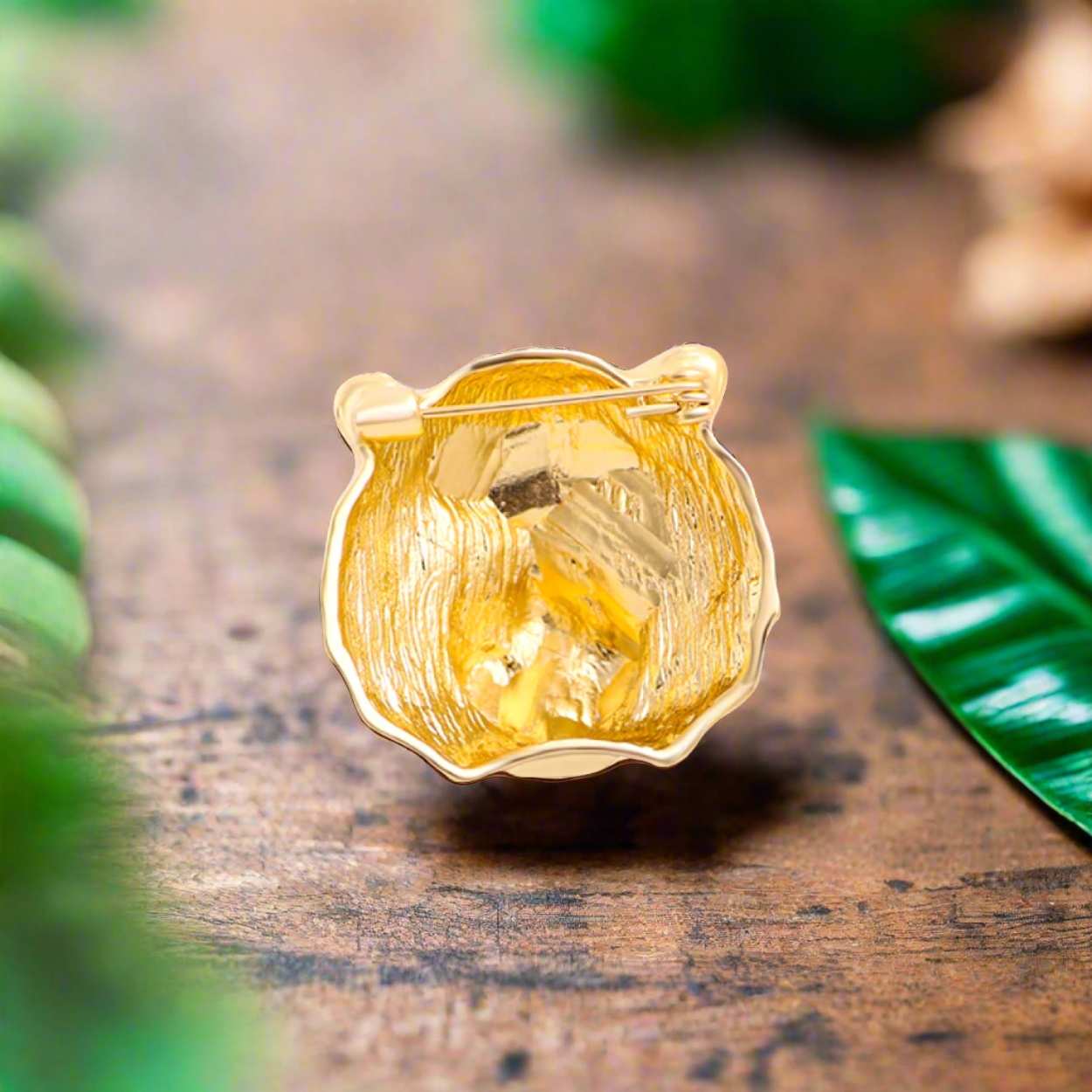 Close-up of a gold tiger head lapel pin with gemstones, showing intricate details and luxury appeal