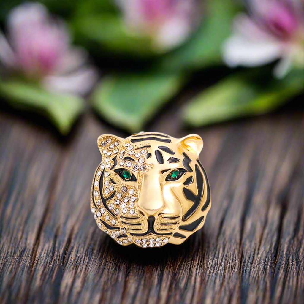 Close-up of a gold tiger head lapel pin with gemstones, showing intricate details and luxury appeal