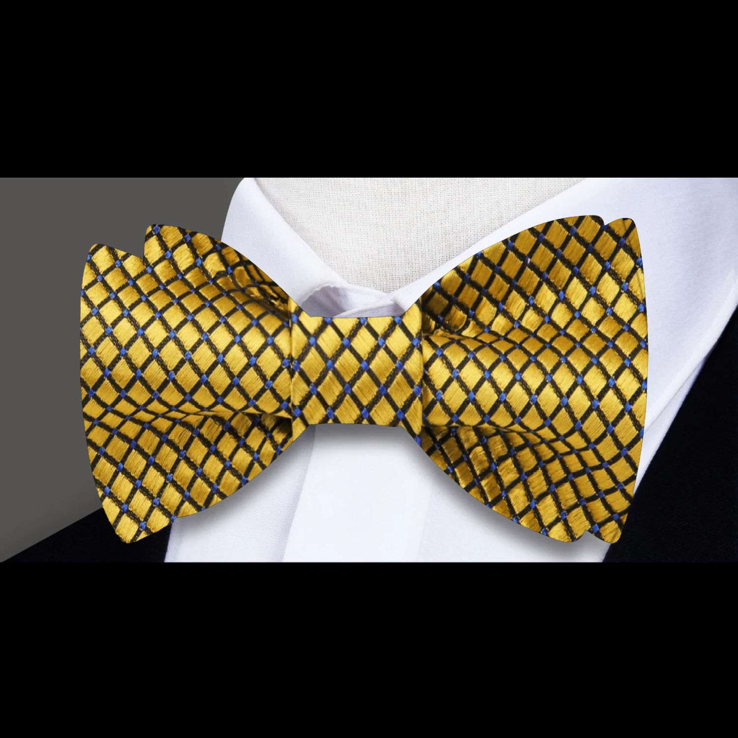 Close-up of a green small check silk bow tie paired with a blue dress shirt for a sophisticated look
