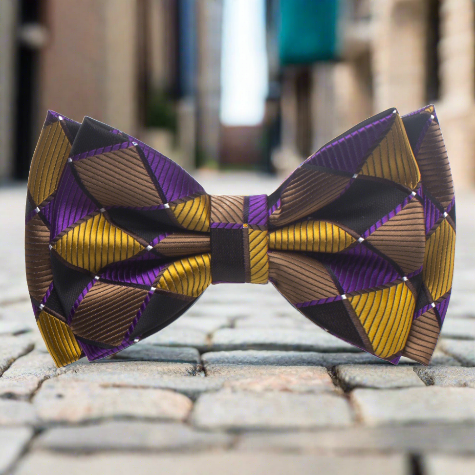 Elegant geometric bow tie showcasing rich gold, purple, and brown colors, perfect for formal wear.