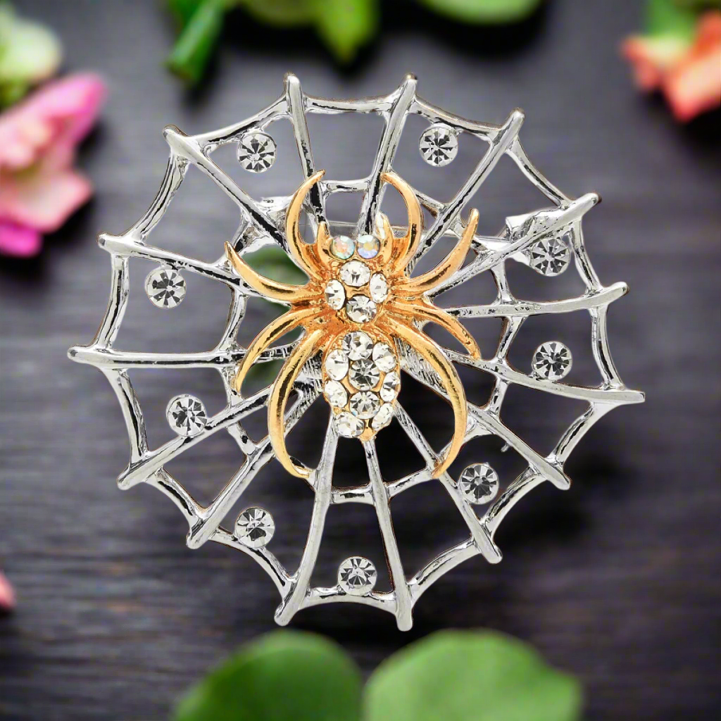 Close-up detail of the spider web and spider design in silver and gold