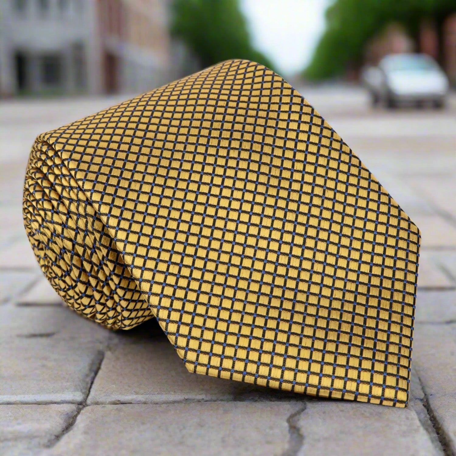 Close-up of the opulent gold geometric silk necktie showcasing its intricate design and texture.
