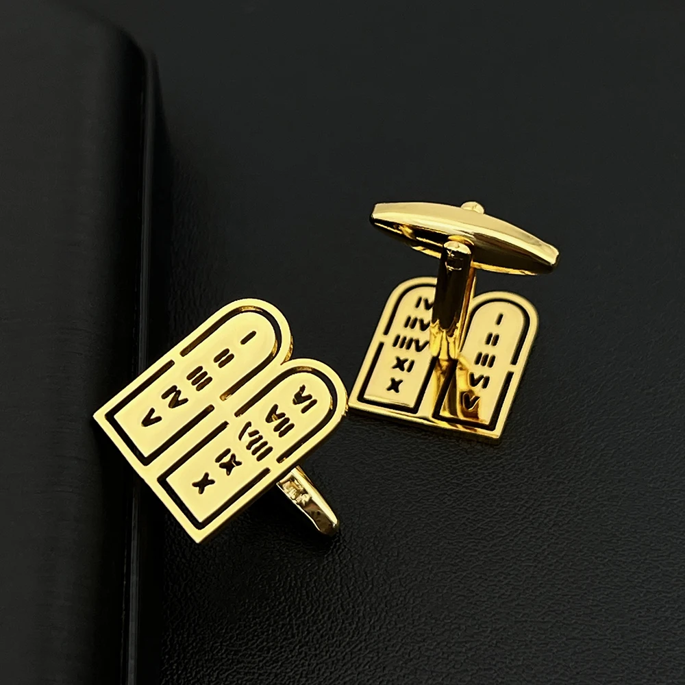 Man wearing gold commandment jewelry cufflinks with suit for wedding