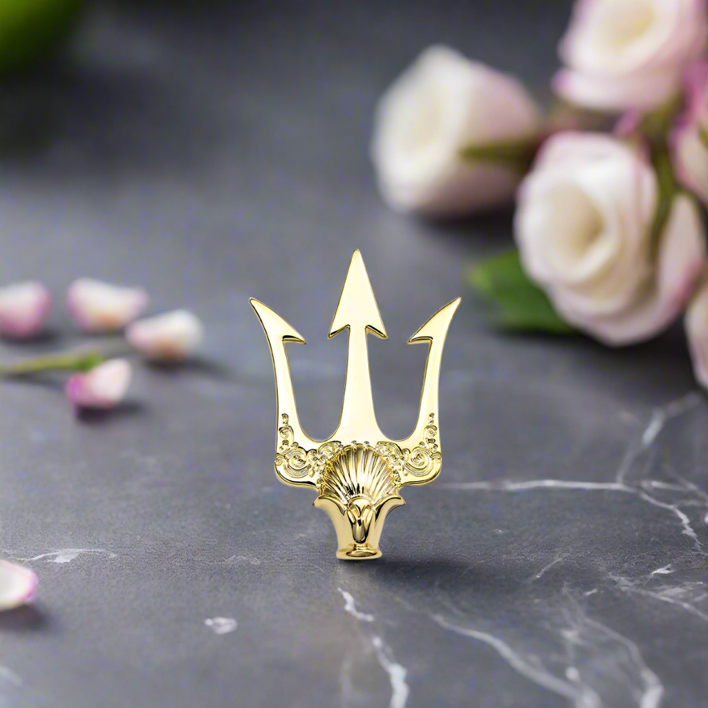 Front view of the gold trident lapel pin on a classic white dress shirt