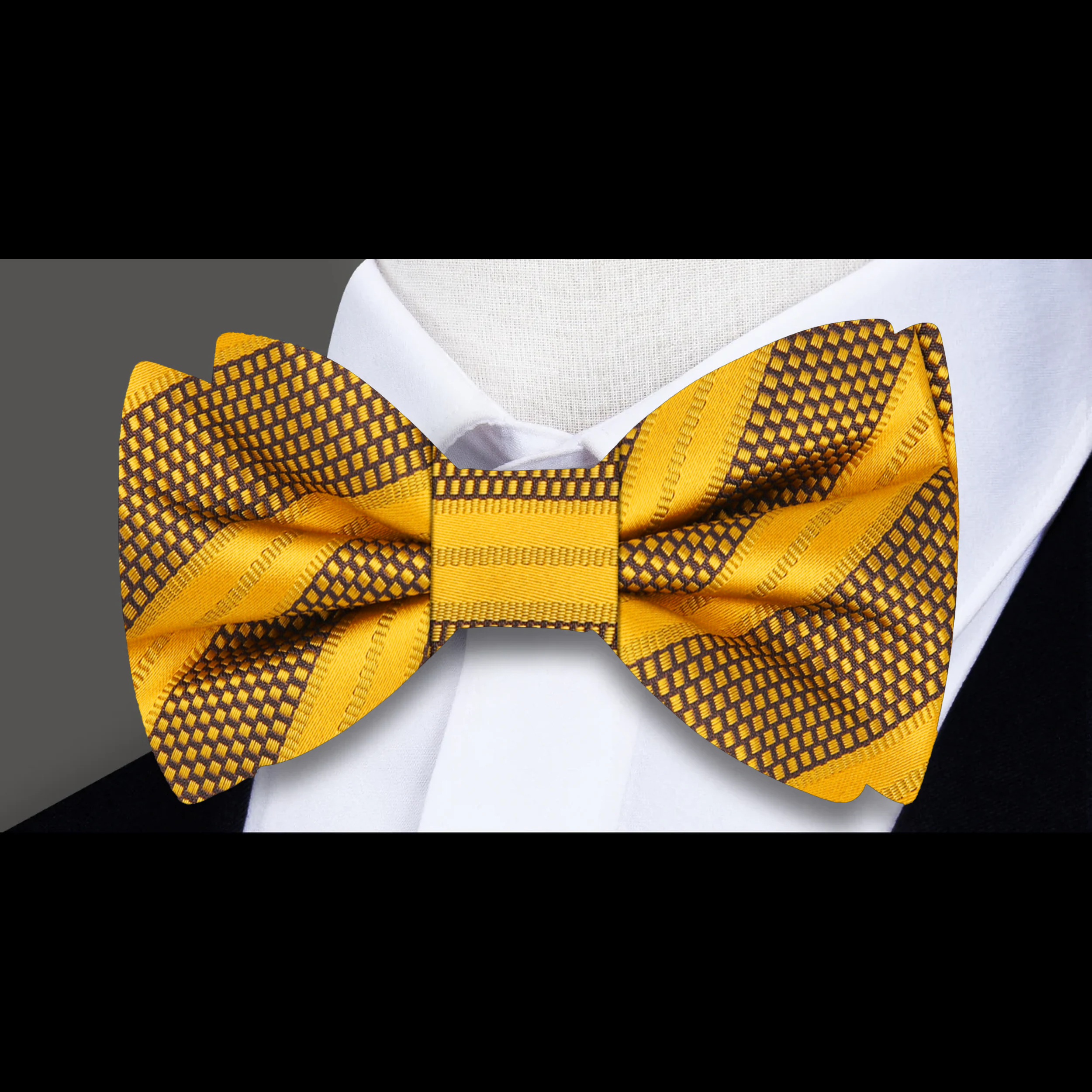 Close-up of the fabric pattern and texture of a yellow gold striped bow tie