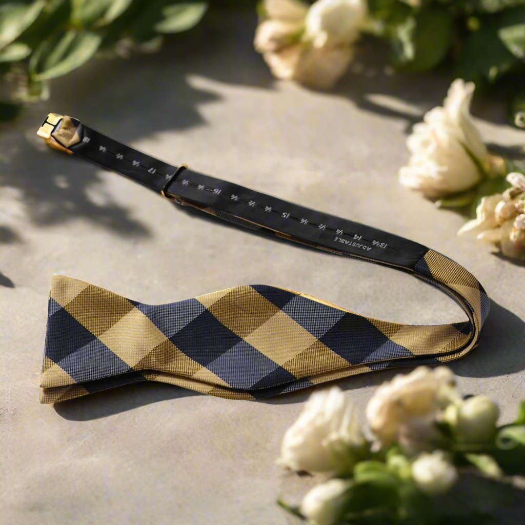 Close-up of a stylish mens plaid bow tie with a self-tie knot, perfect for weddings