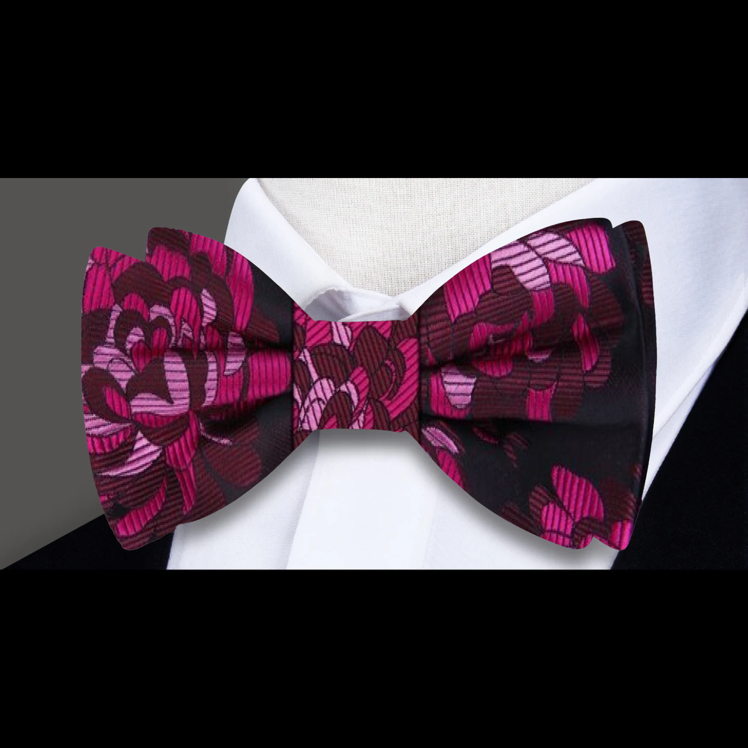 Close-up of the pink floral silk bow tie, highlighting the detailed floral design and luxurious silk fabric.