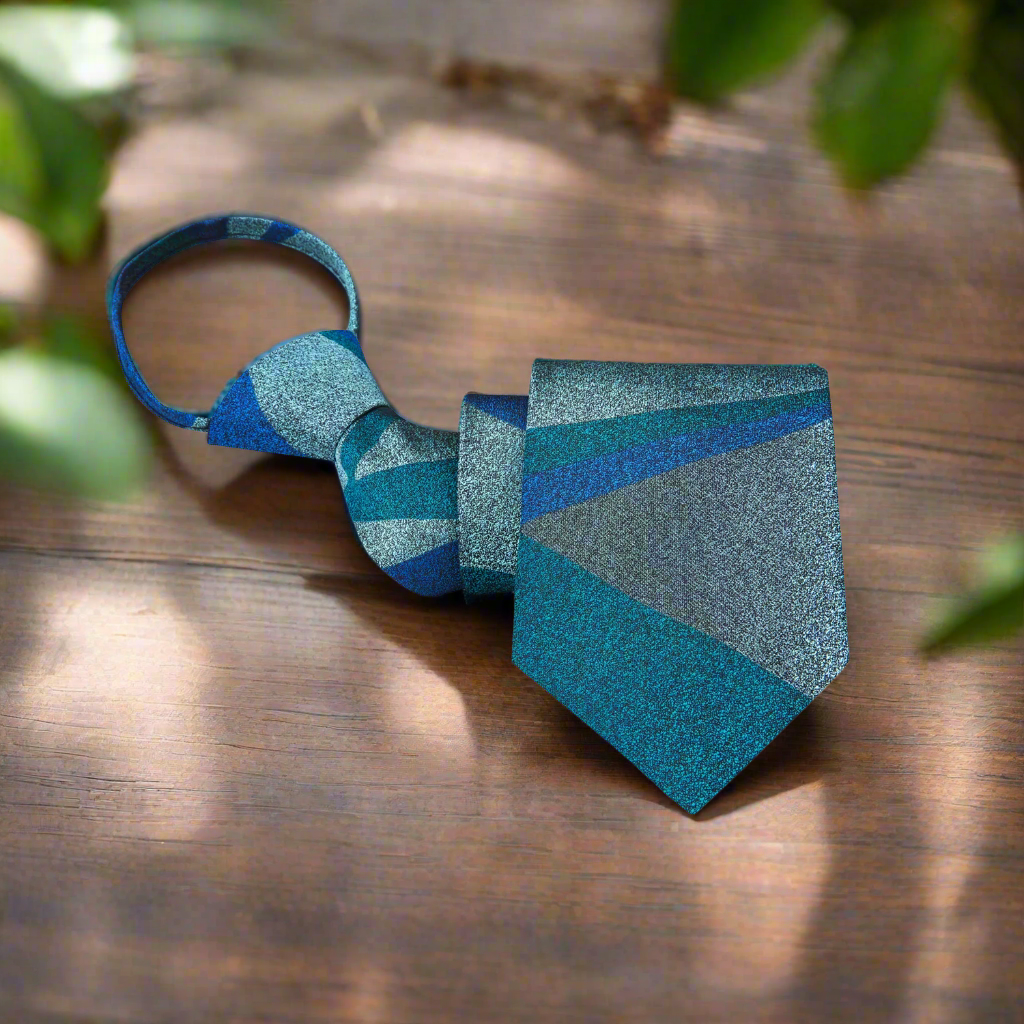Close-up of textured teal silk tie with abstract pattern