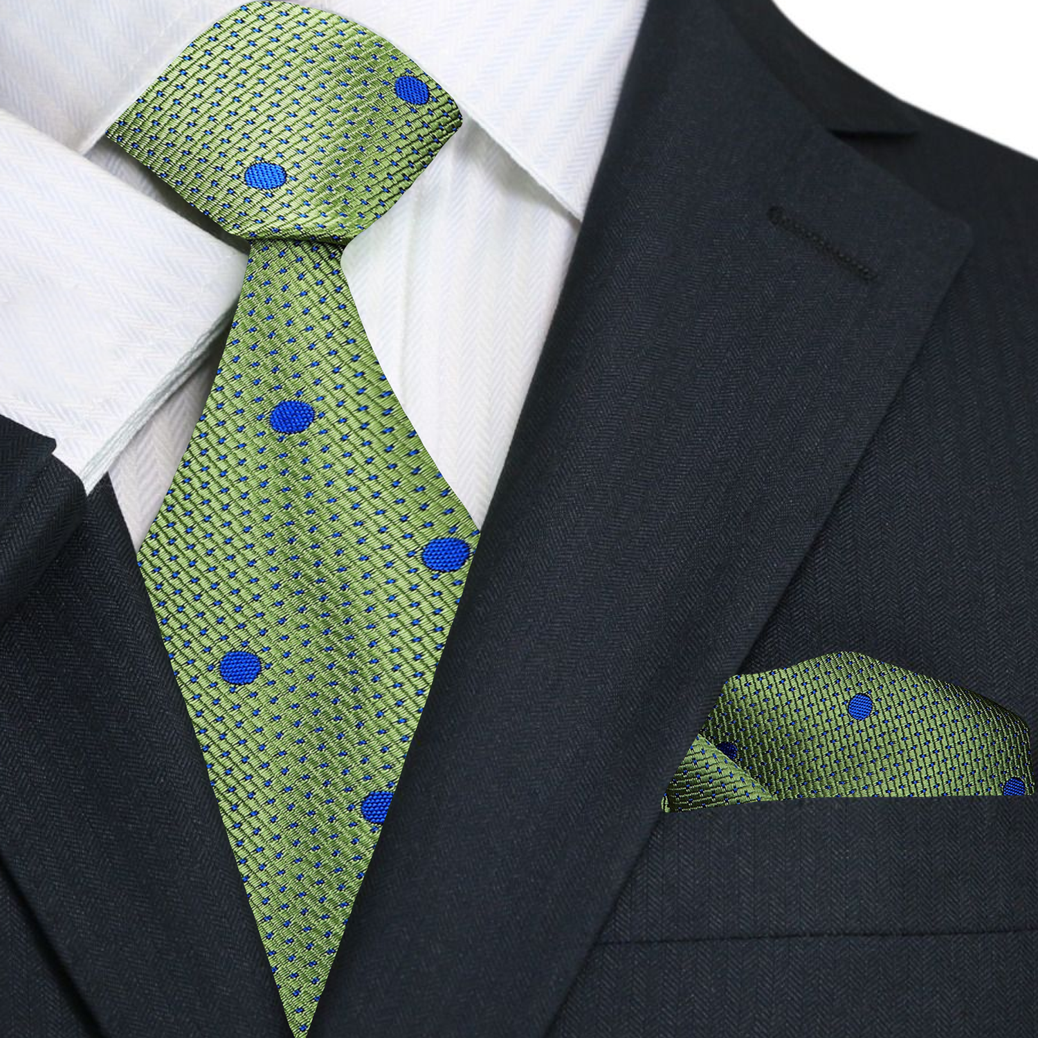 Detail view of the green and blue polka dot silk necktie draped on a hanger