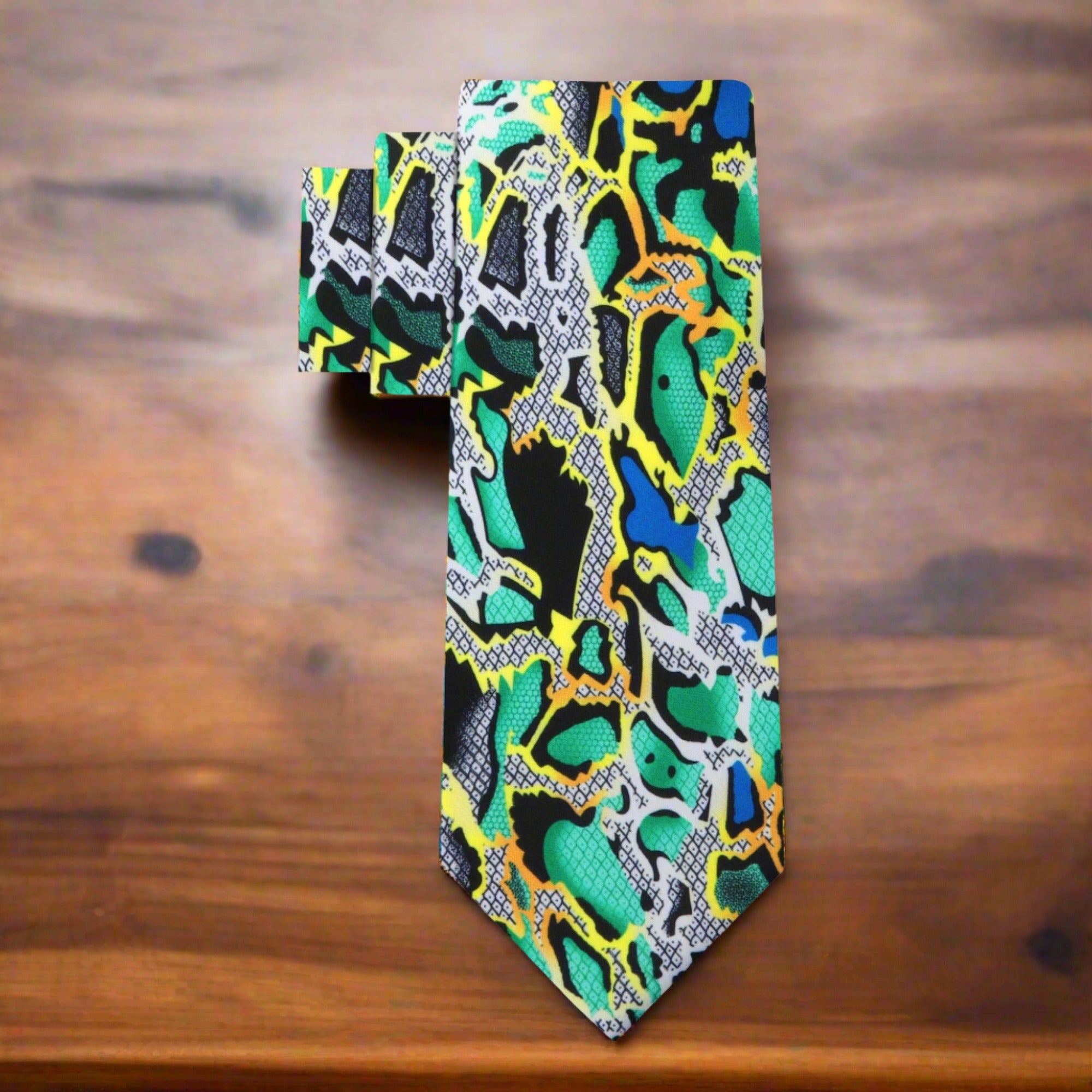 Close-up of digital snakeskin pattern on a luxury silk necktie in bold colors