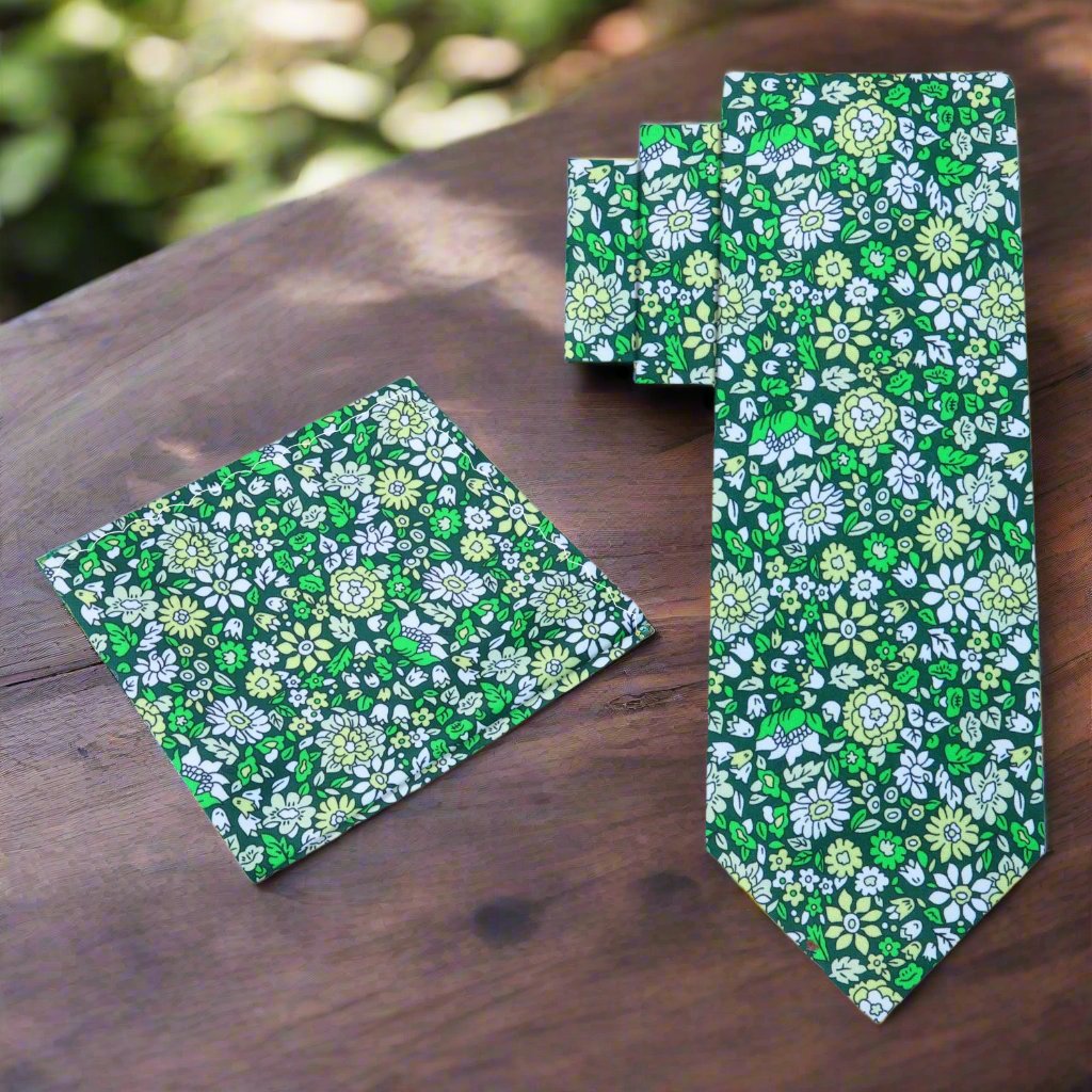 Model wearing a floral silk necktie with a white dress shirt and navy suit