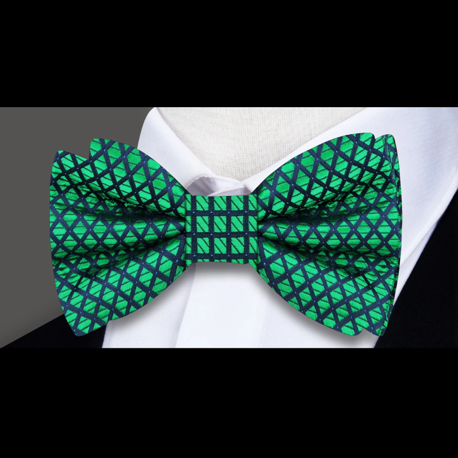 Man wearing a vibrant green geometric bow tie with a white dress shirt