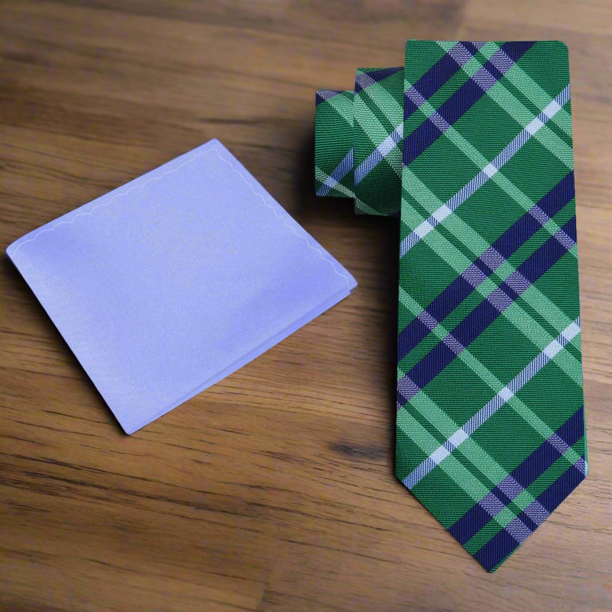 Styled image of a man wearing a green plaid silk tie with a navy suit for a wedding