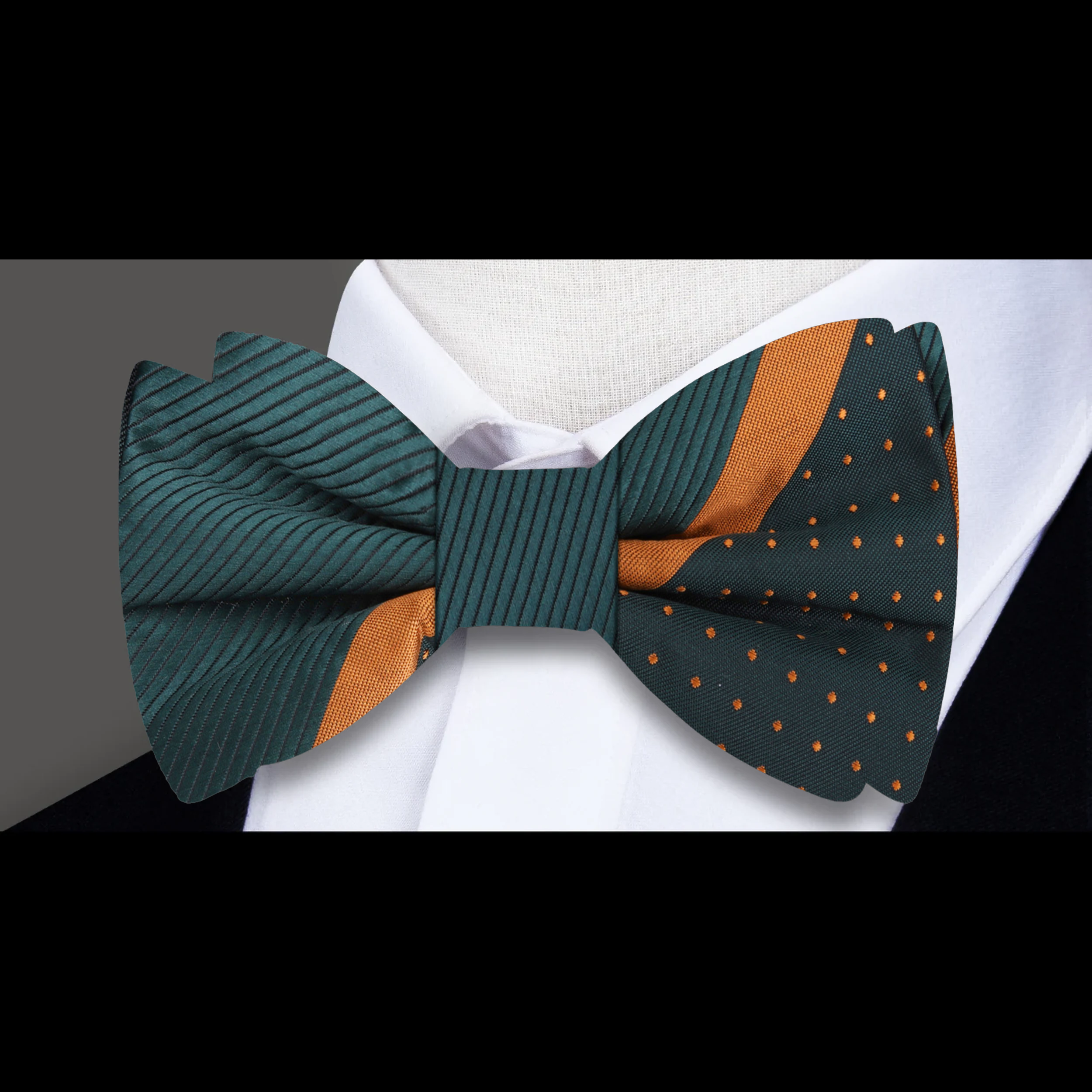 Deep green silk bow tie styled with a white dress shirt and charcoal suit