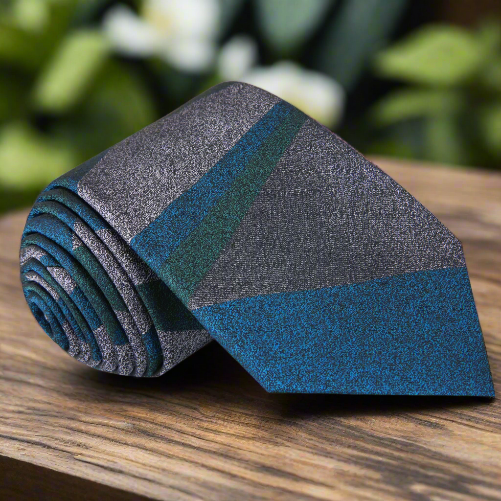 Close-up of the zipper tie mechanism on a teal luxury silk necktie, showcasing its elegant design.