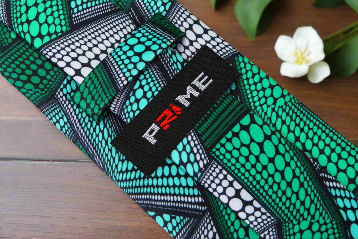 Close-up of the green Kente necktie paired with a crisp white shirt, ideal for formal occasions.