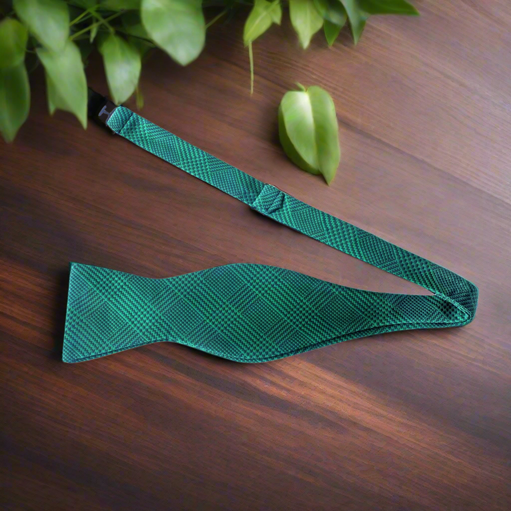 Elegant green plaid silk bow tie styled with a navy suit for a wedding