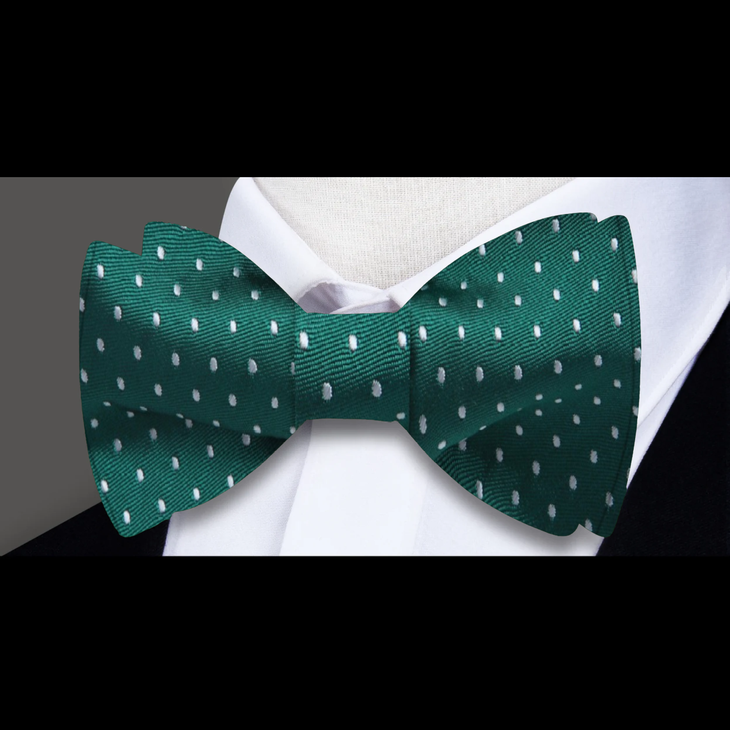 Green microdot silk bow tie styled with a white pinpoint oxford shirt for a classic look.