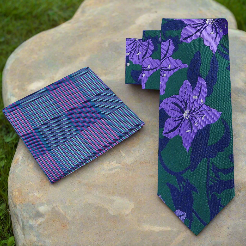 Mens silk necktie with hibiscus pattern, styled with a navy blue suit for a formal look.