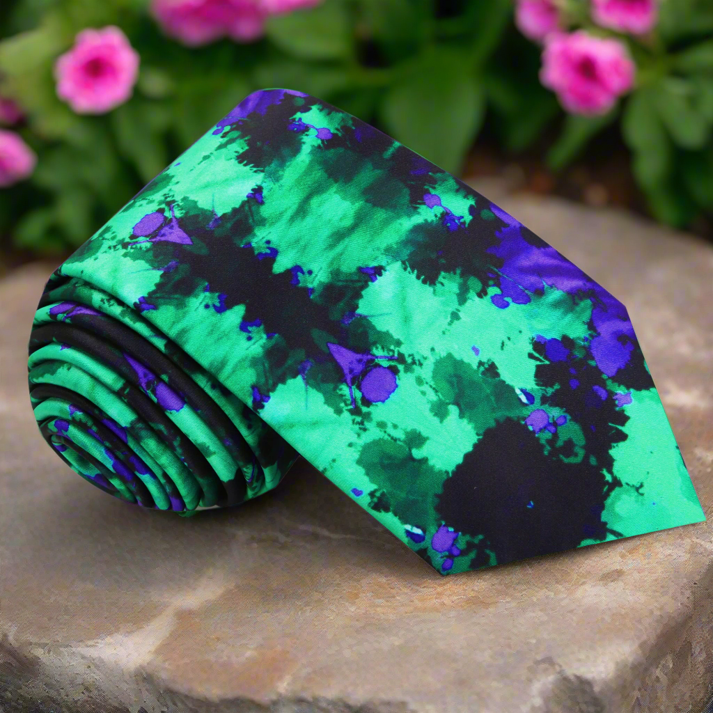 Close-up of stylish ink blot silk necktie showcasing vibrant patterns.