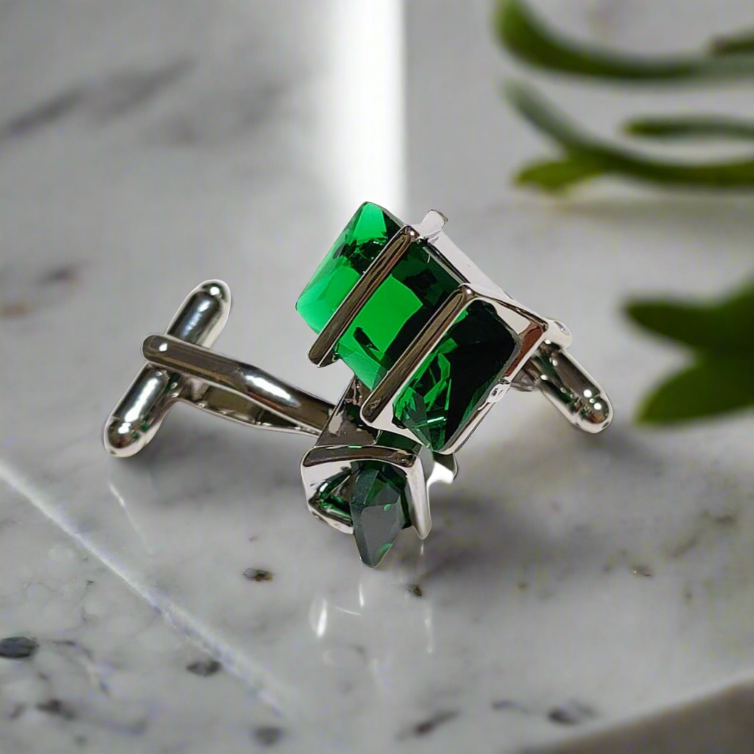 Side angle of chrome greenstone cufflinks displayed on a formal shirt, emphasizing their elegance.