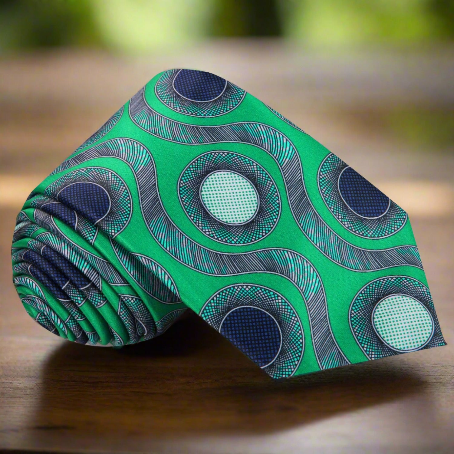 Elegant silk necktie with snake and circle pattern in green and blue, ideal for formal events