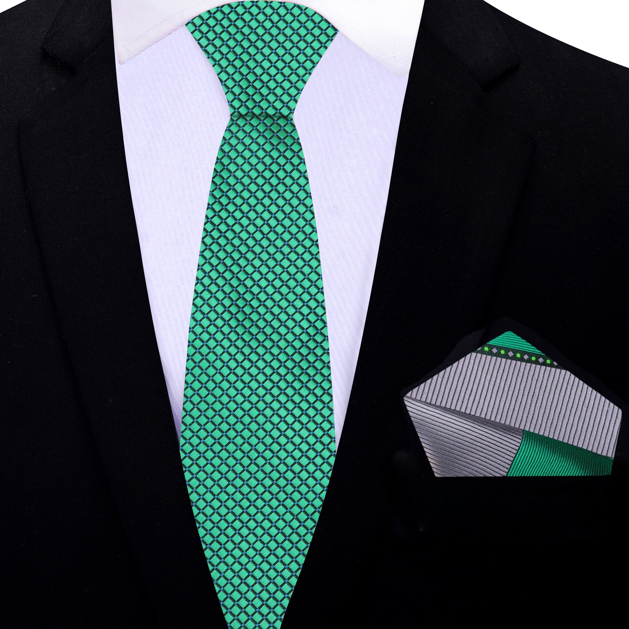 Elegant green geometric silk tie displayed on a white dress shirt, perfect for formal occasions.