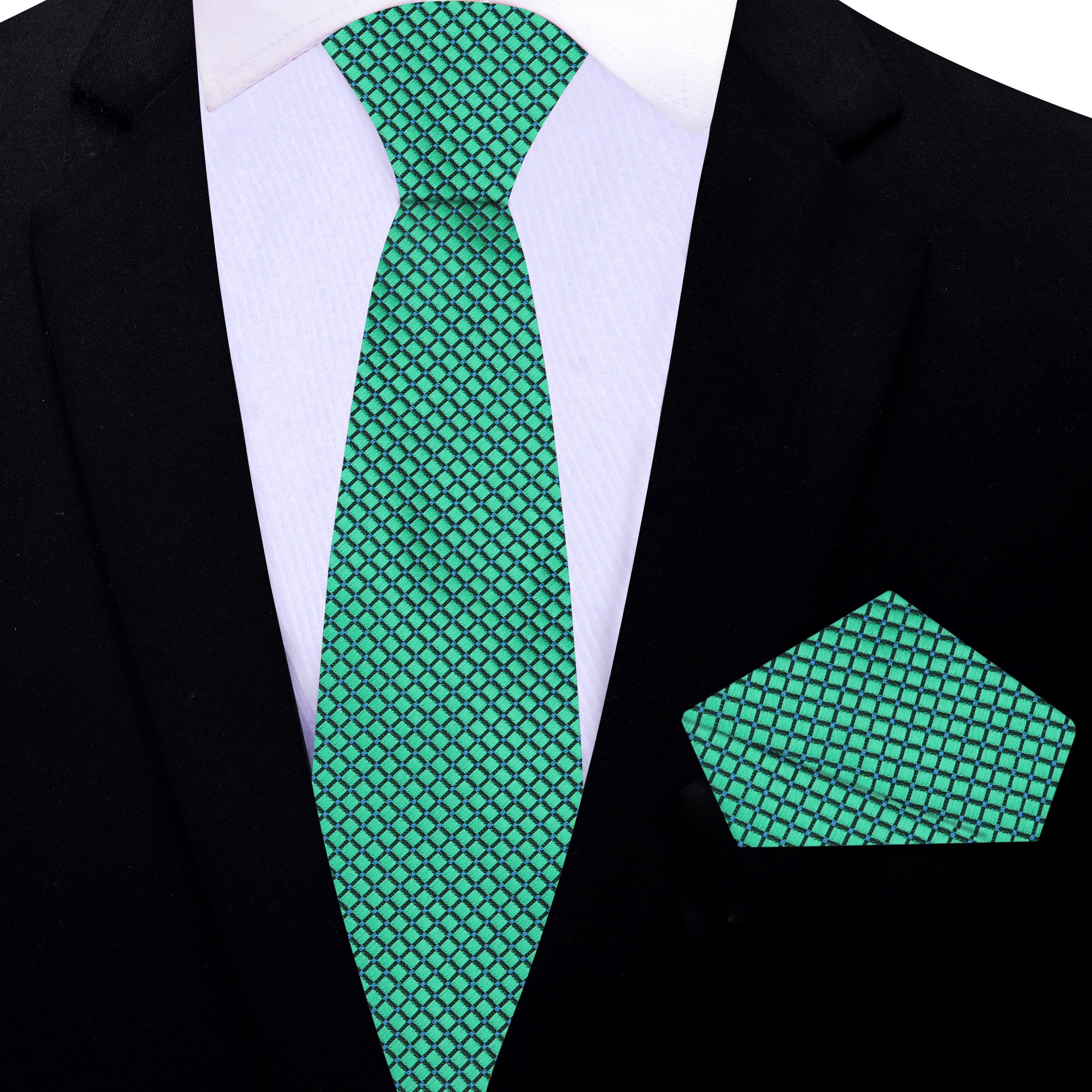 Close-up of the geometric pattern on the green silk tie, showcasing its intricate design.