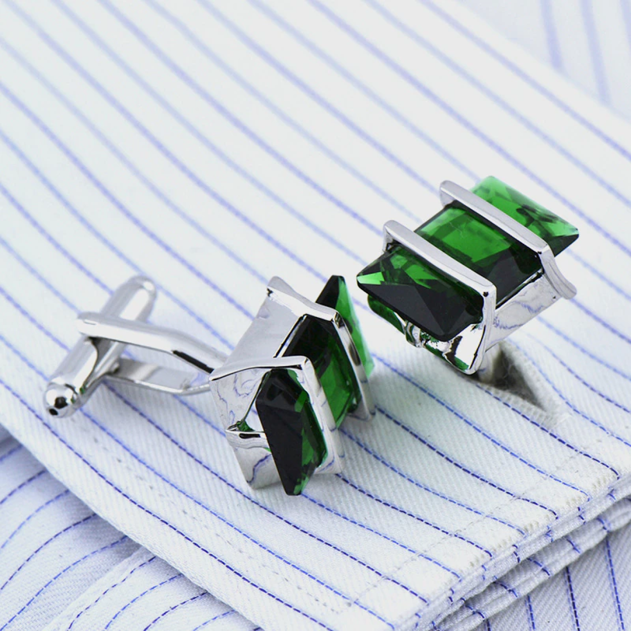 Close-up view of chrome greenstone cufflinks highlighting the intricate design and vibrant stones.