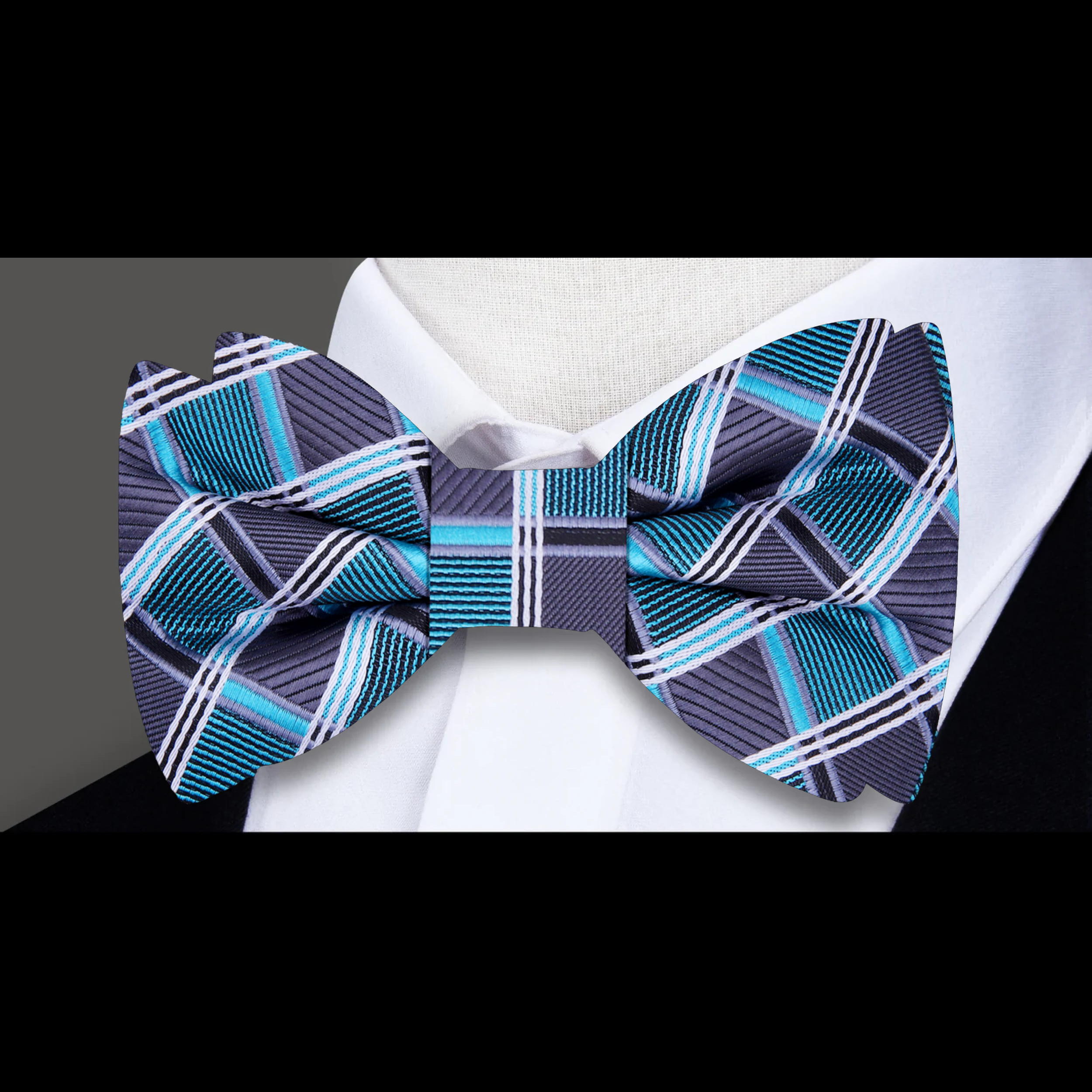 Close-up of the silk fabric and diamond plaid pattern of the mens plaid bow tie