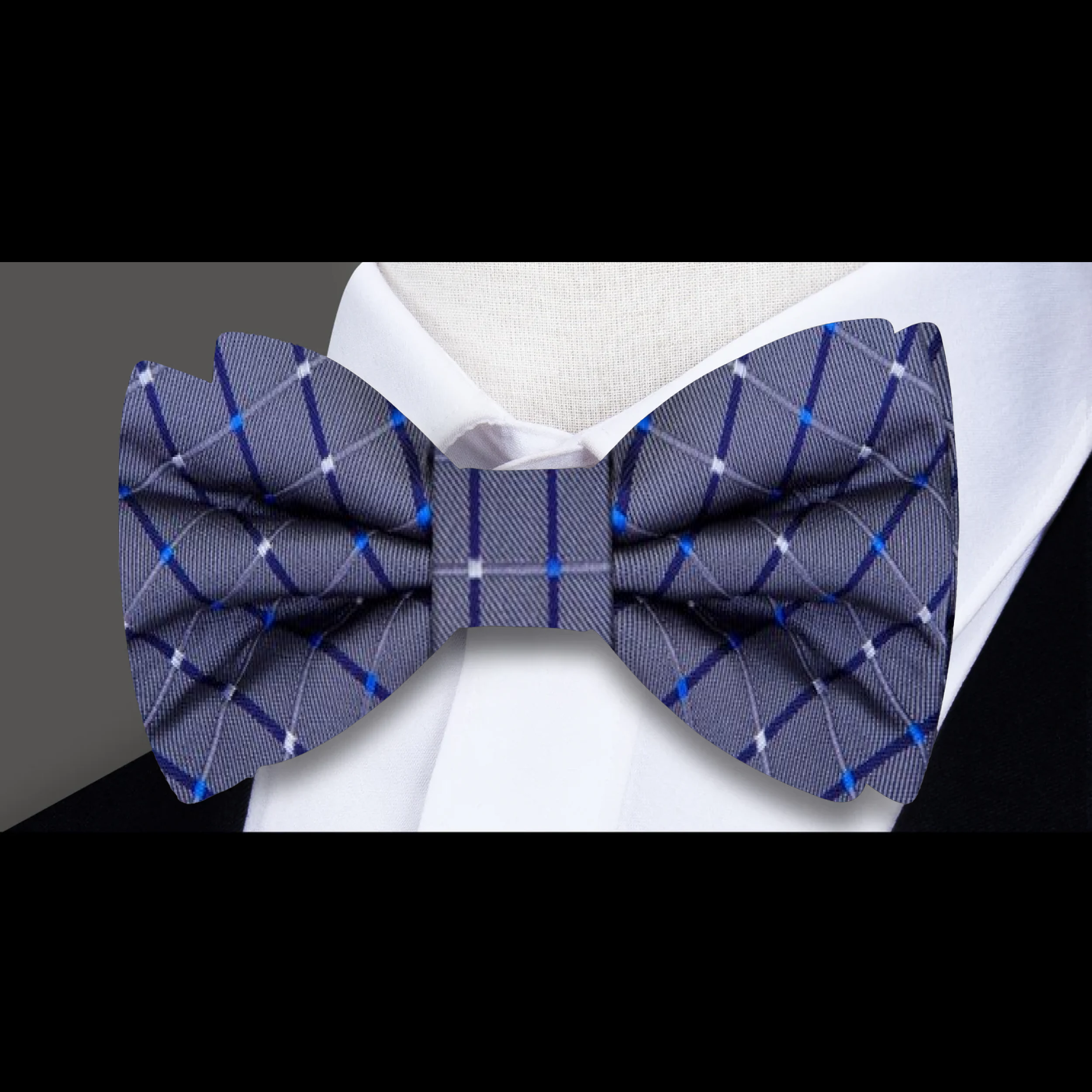 Formal ensemble with silk bow tie and pocket square worn at a business event
