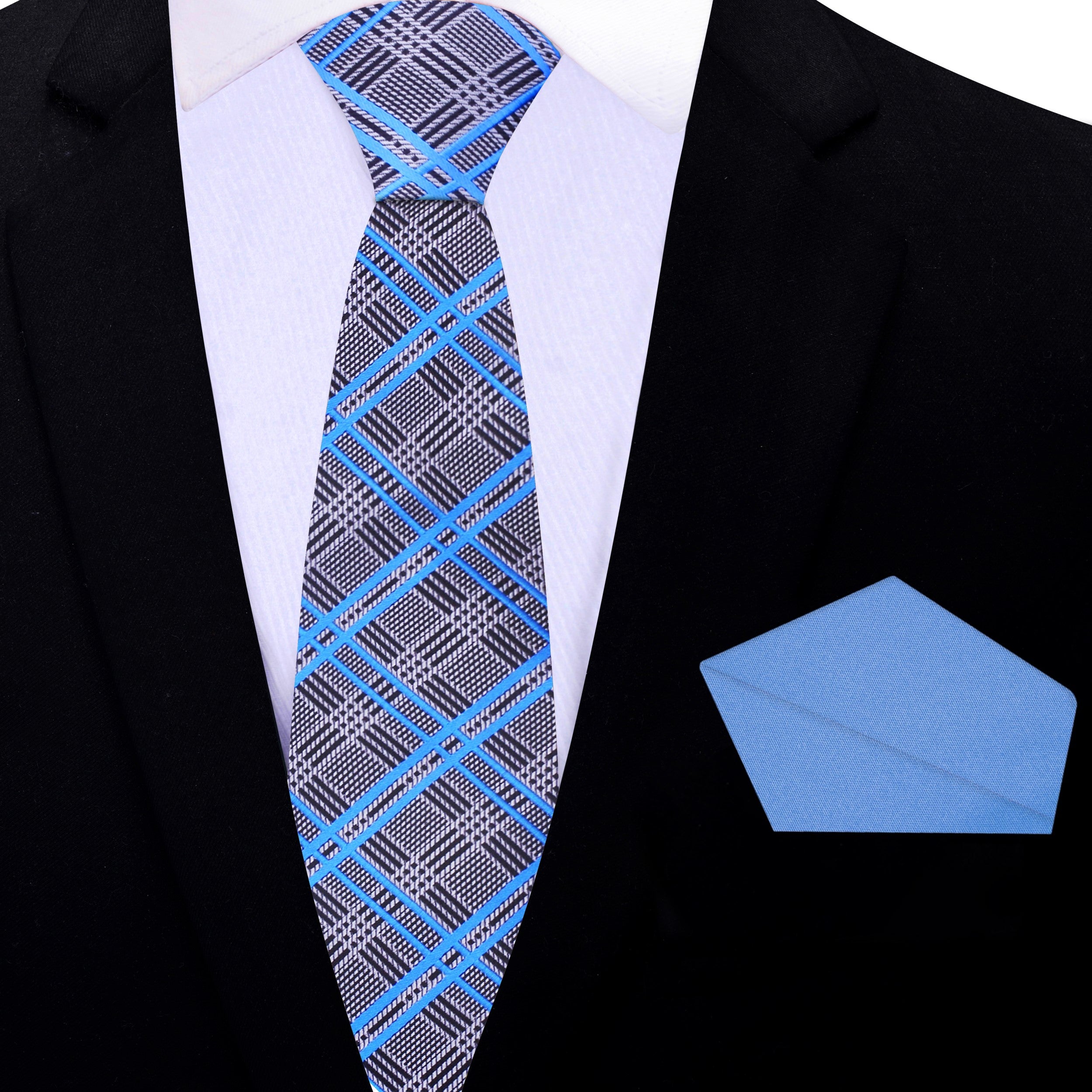 Flat lay of silver plaid mens necktie and matching pocket square, ideal for formal occasions