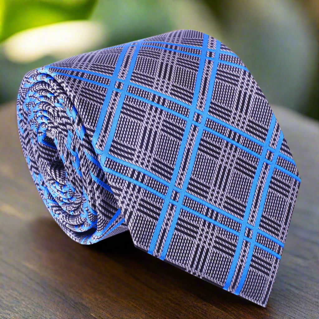 Close-up of silver and blue plaid silk necktie on a hanger, showcasing the pattern and fabric quality