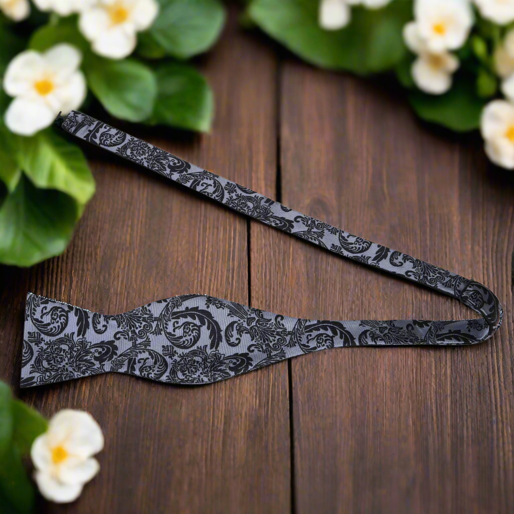 Close-up of vibrant red paisley silk bow tie showcasing intricate pattern