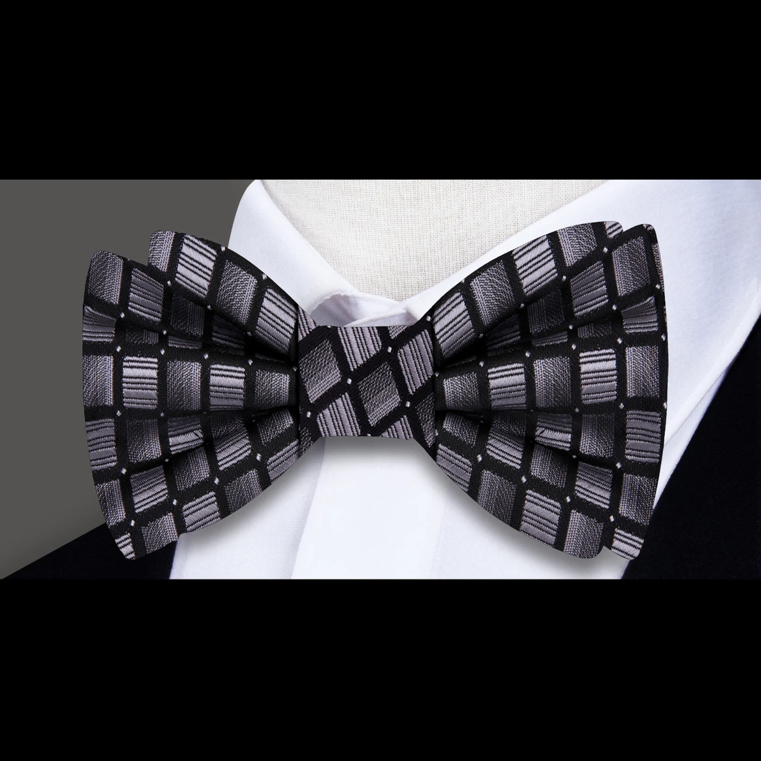 Close-up of the modern silver honeycomb bow tie showcasing its geometric pattern.