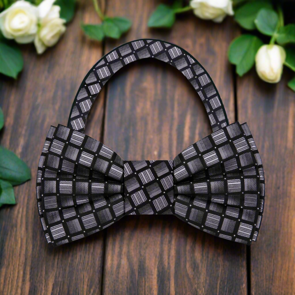 Stylish modern silver honeycomb bow tie worn with a charcoal suit.