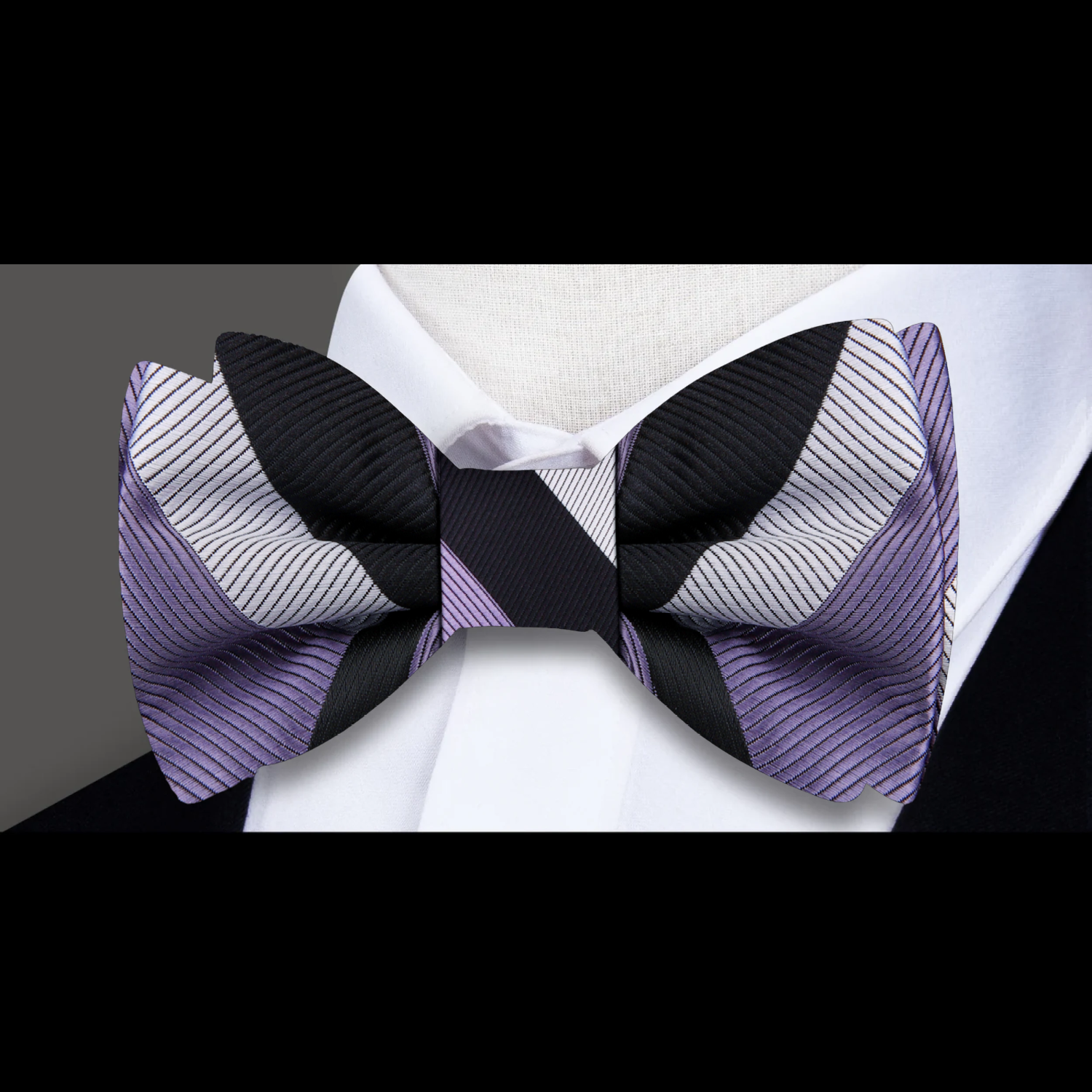 Flat lay of the bow tie and matching pocket square, highlighting the silk texture and bold color combinations