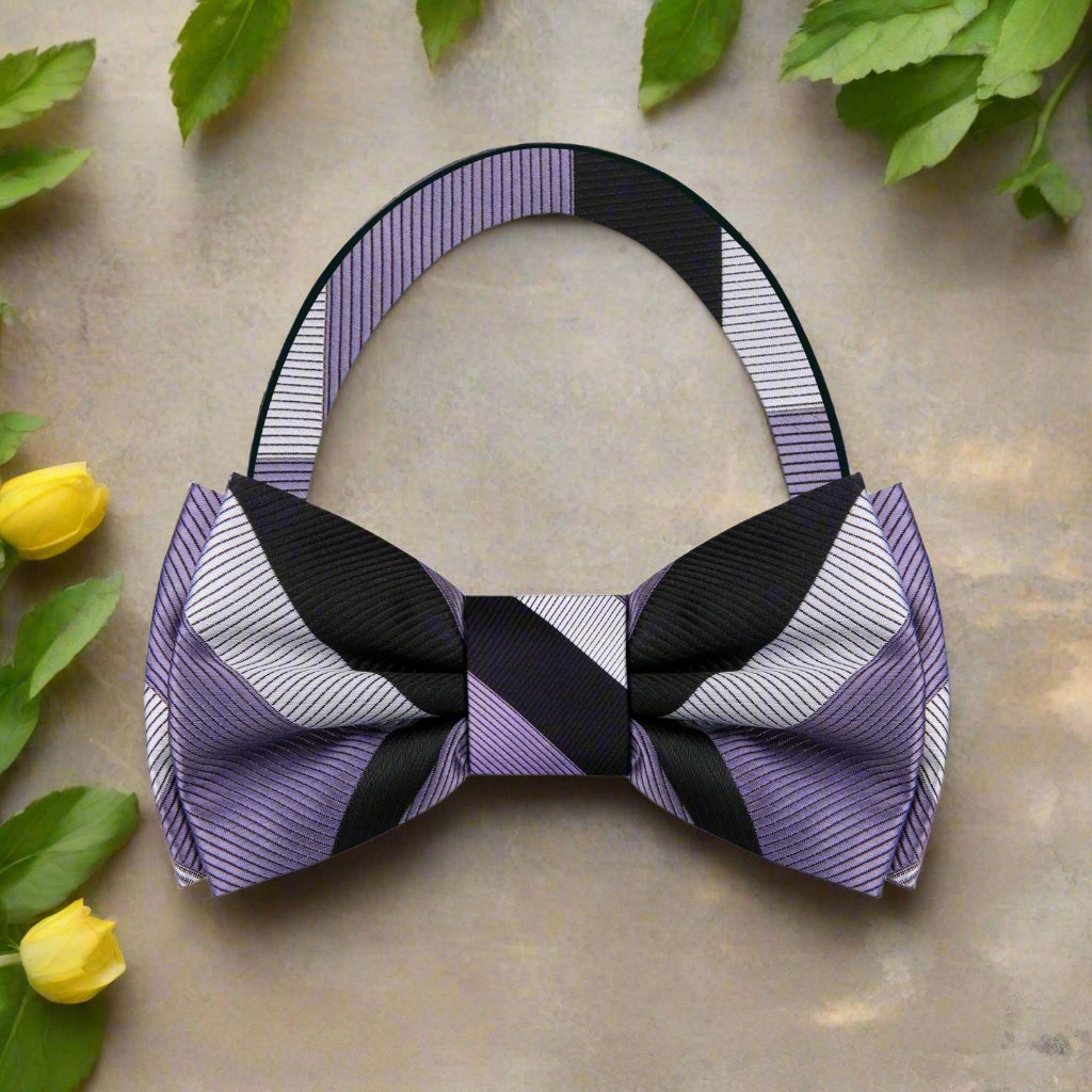 Styled on a pale grey micro-houndstooth shirt with a charcoal suit, showcasing the bow tie’s formal versatility