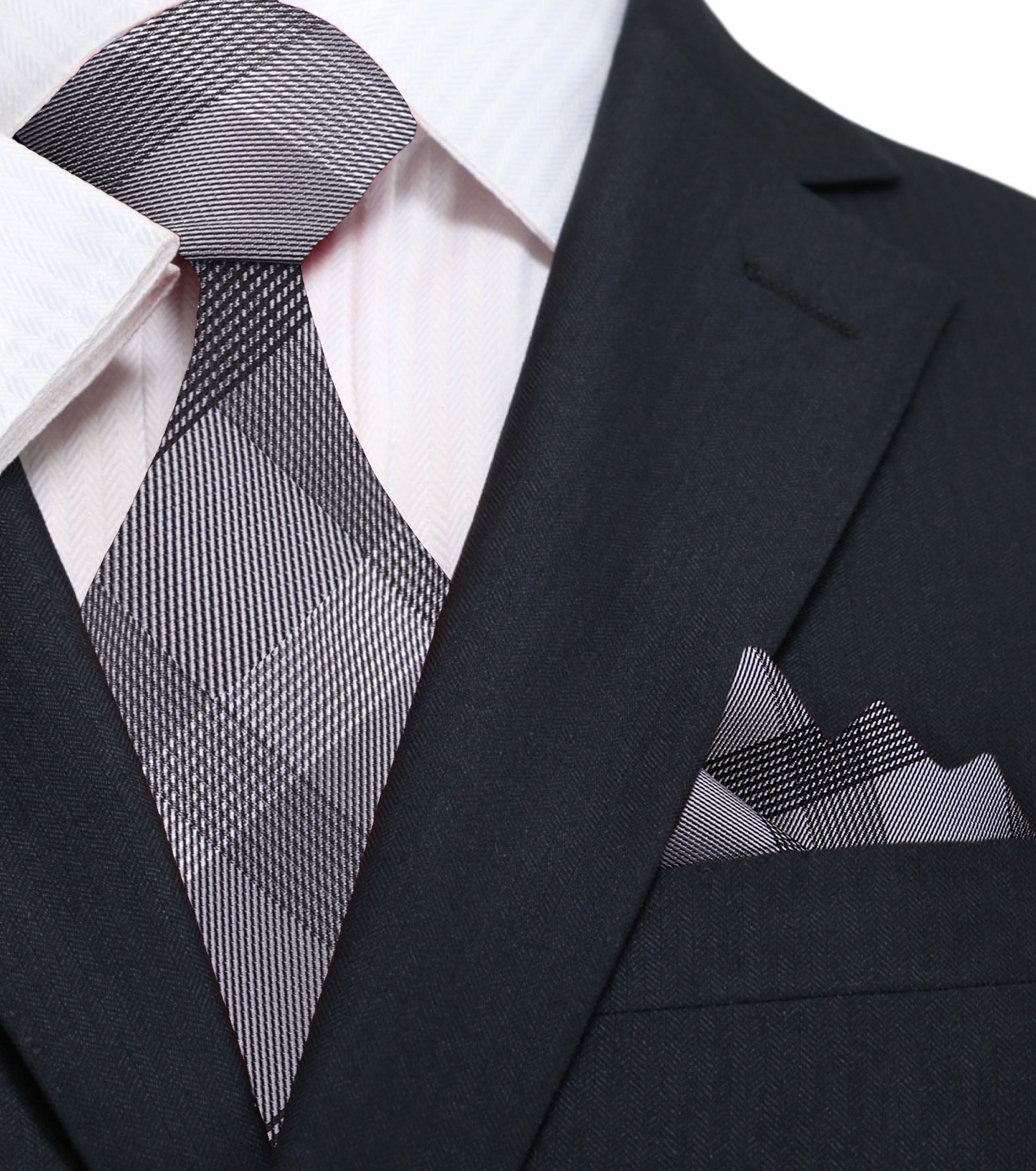 Flat lay of the tie and matching pocket square showing silk texture and plaid detail
