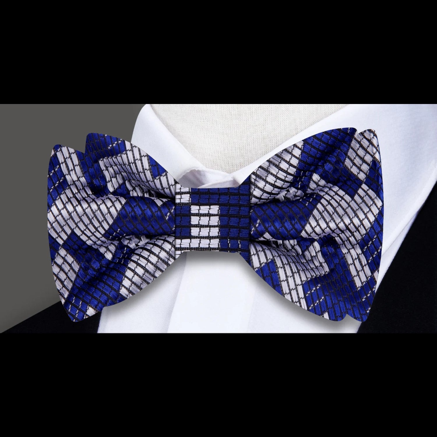 Model wearing a silk houndstooth bow tie with a classic white dress shirt