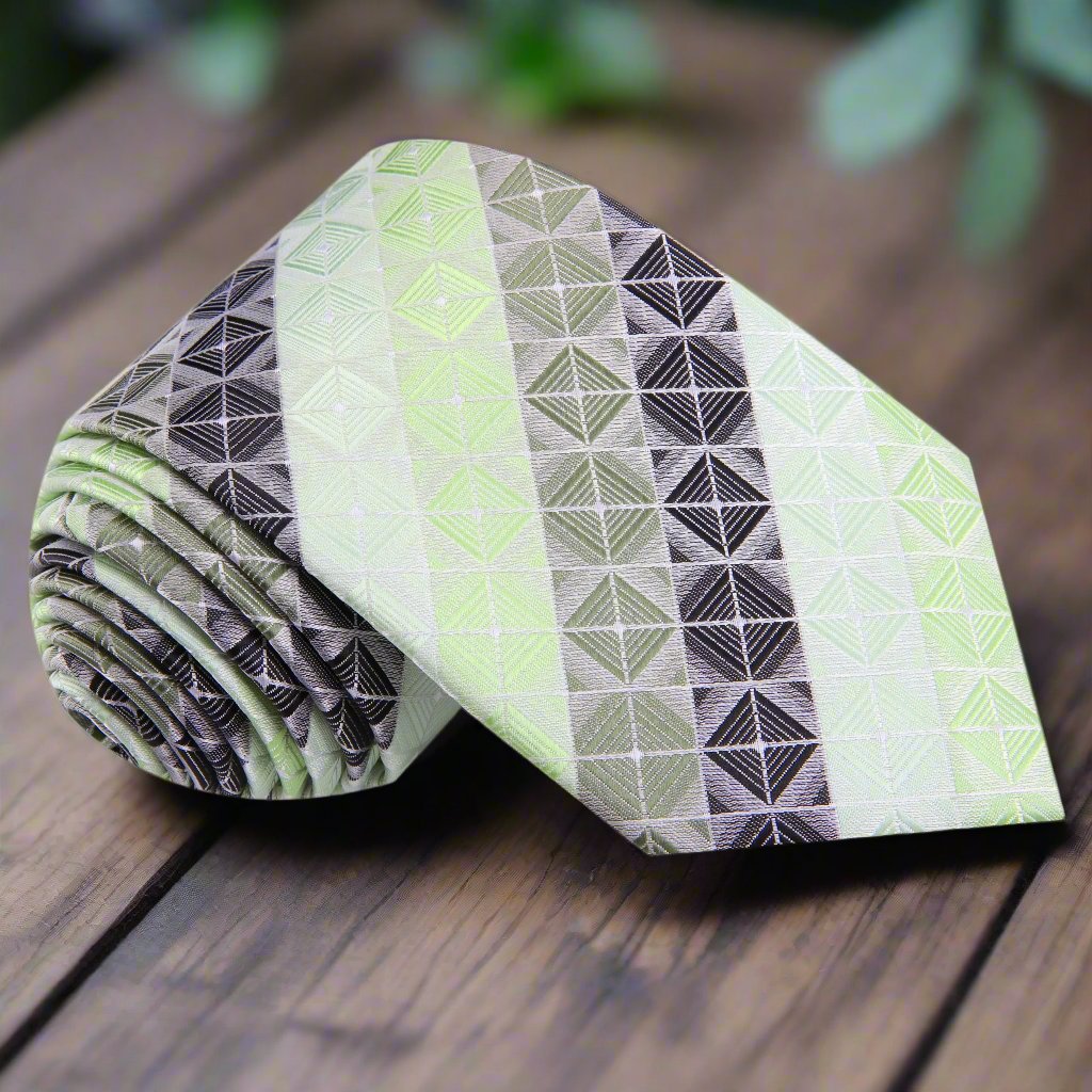 Silk necktie with geometric blocks pattern in green and grey, styled with a white dress shirt