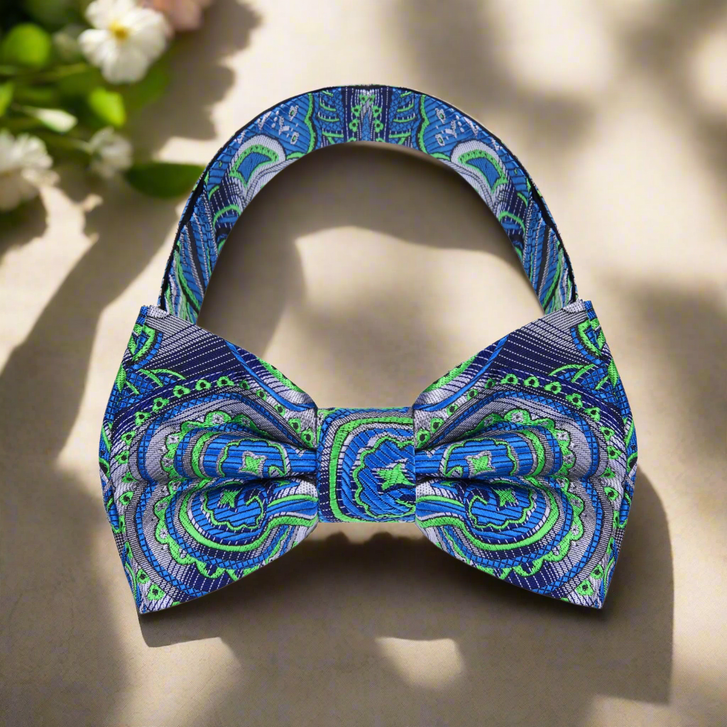 Close-up of the Tropics Paisley Bow Tie displaying intricate details, paired with a crisp white dress shirt.