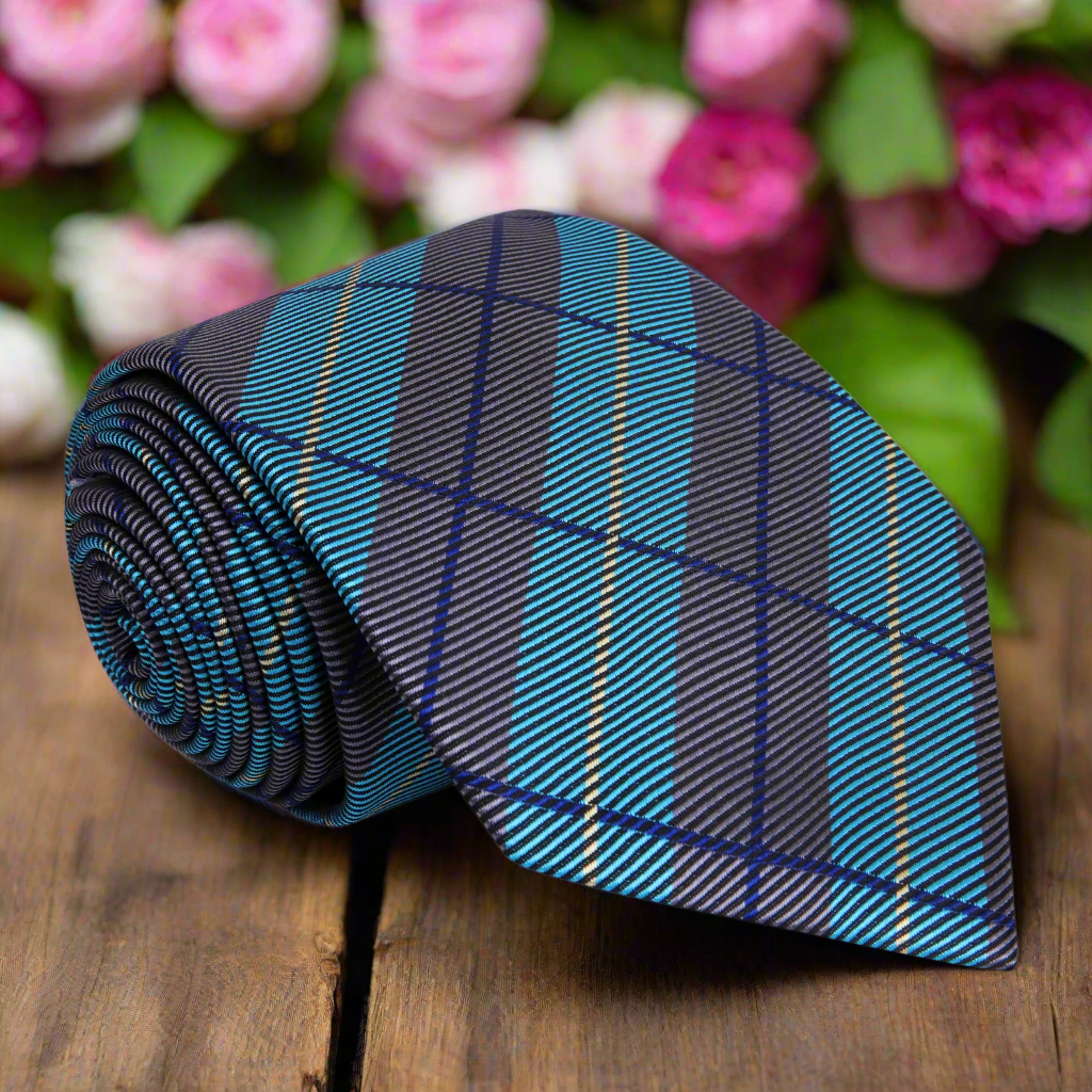 Close-up of men's plaid silk necktie with dark grey and teal pattern