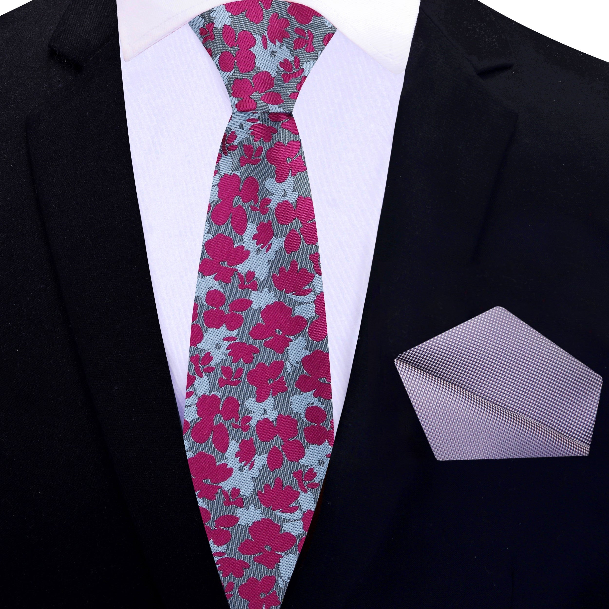Close-up of the floral tie showing soft grey and blush tones