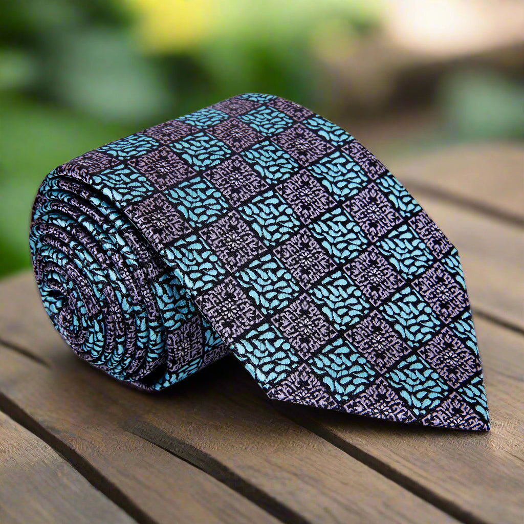 Close-up of geometric pattern on grey and light blue silk necktie