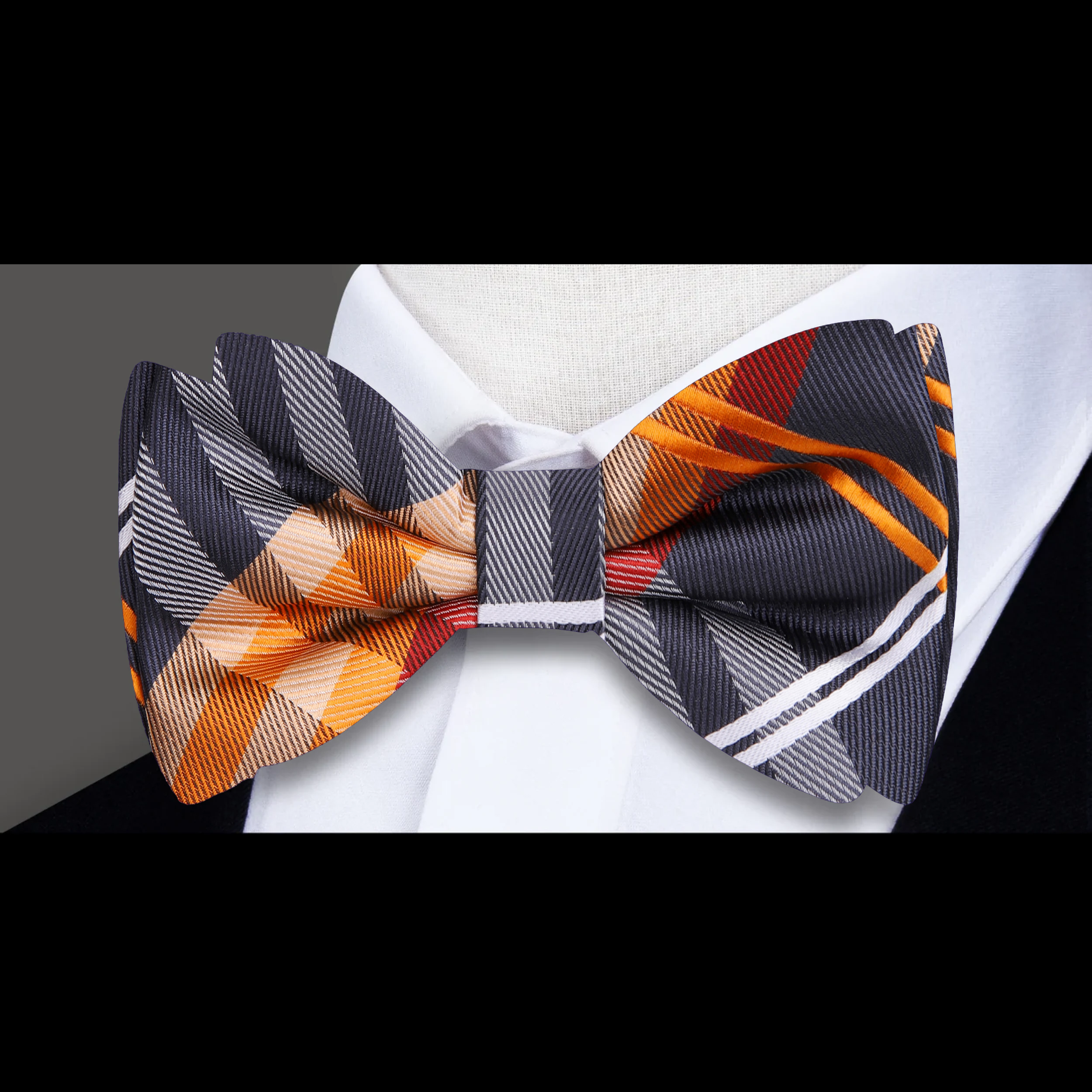 Men tying a plaid bow tie in a modern office setting