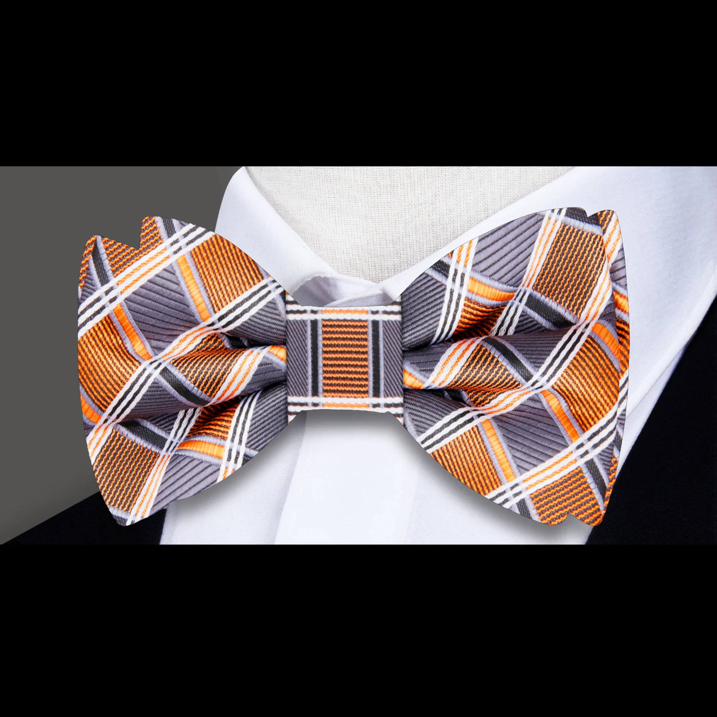 Close-up of the silk fabric and diamond plaid pattern of the mens plaid bow tie