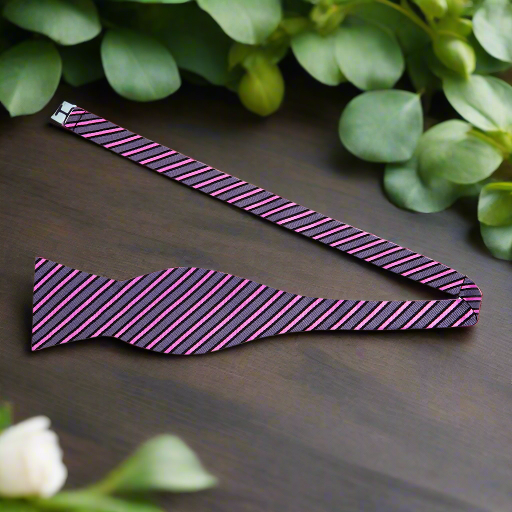Close-up of premium silk stripe bow tie with matching pocket square set for formal wear