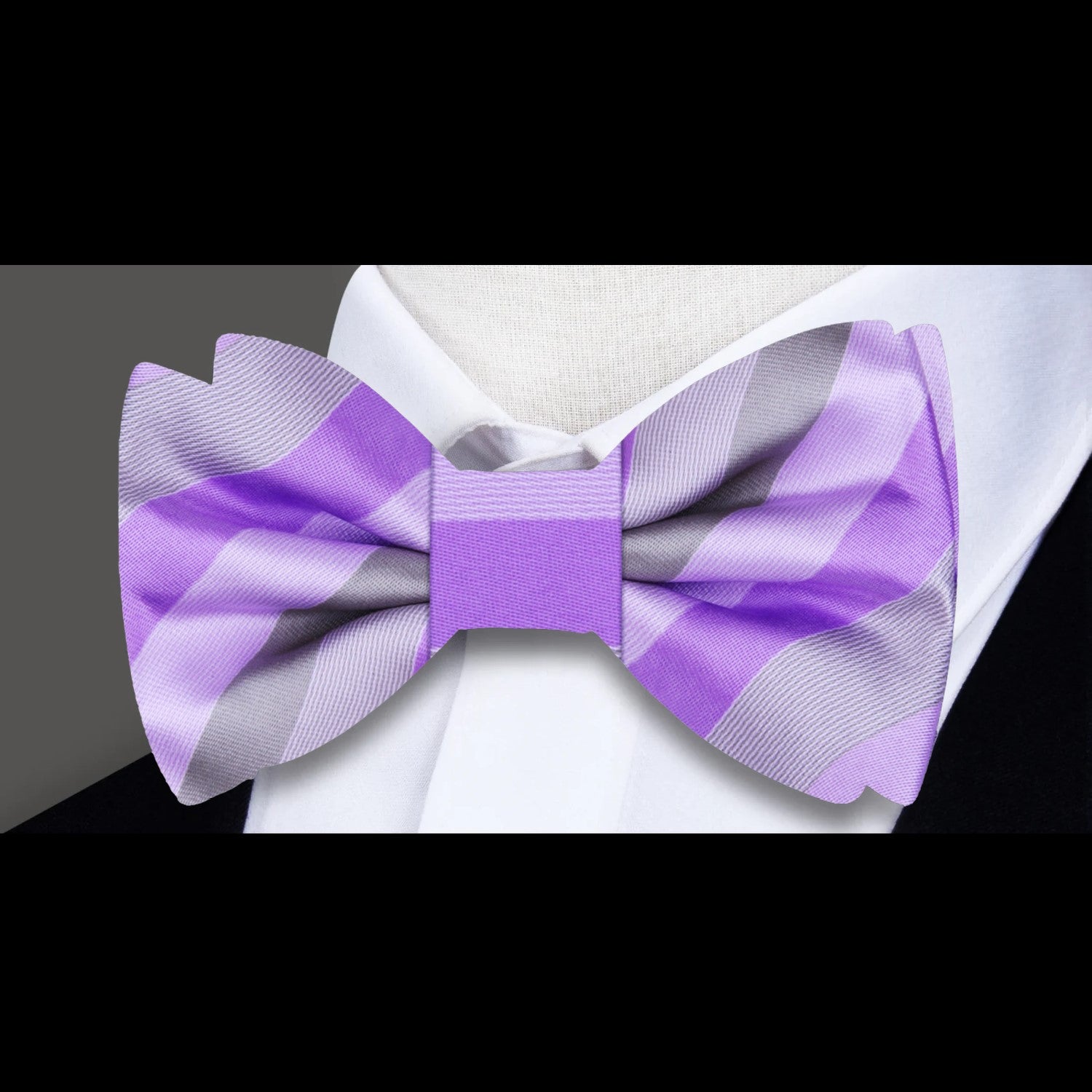 Elegant pastel striped bow tie styled on a crisp white dress shirt.
